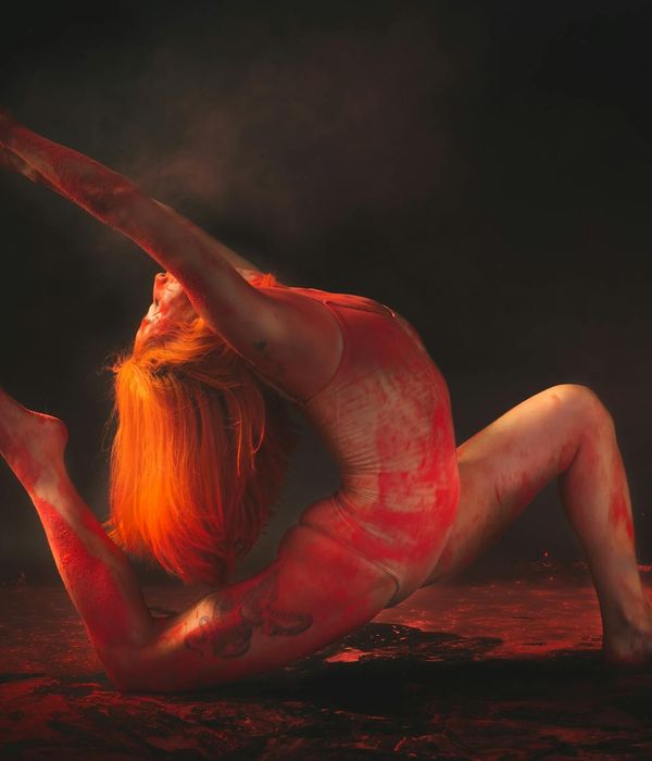Person performing a graceful and energetic yoga pose in a bright room.